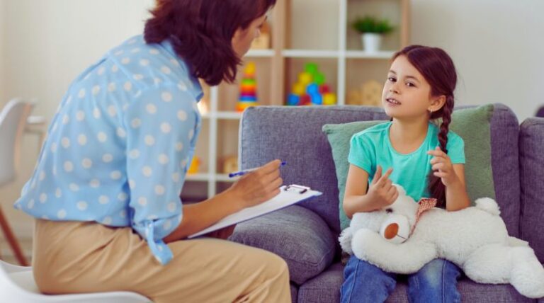 Therapist working with a child during applied behavior analysis (ABA) or a behavioral therapy session.