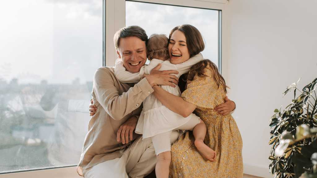 Parents embracing their child at home, illustrating how act in aba supports parental resilience, emotional acceptance, and reduced stress.