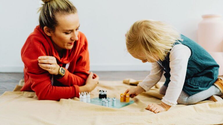Adult and child playing together during therapy to support communication and autism levels care.