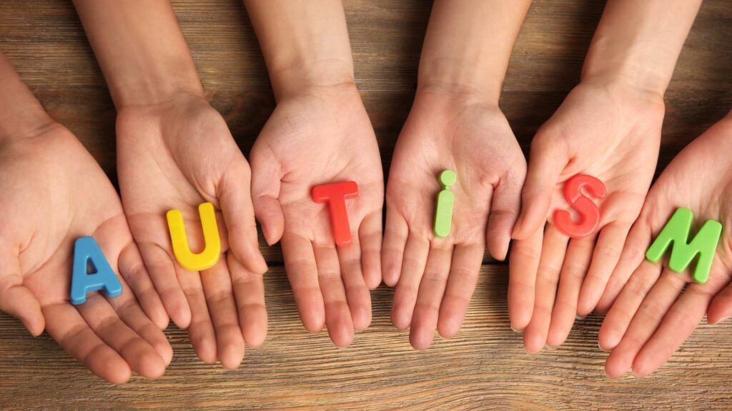 Autism word on people hands
