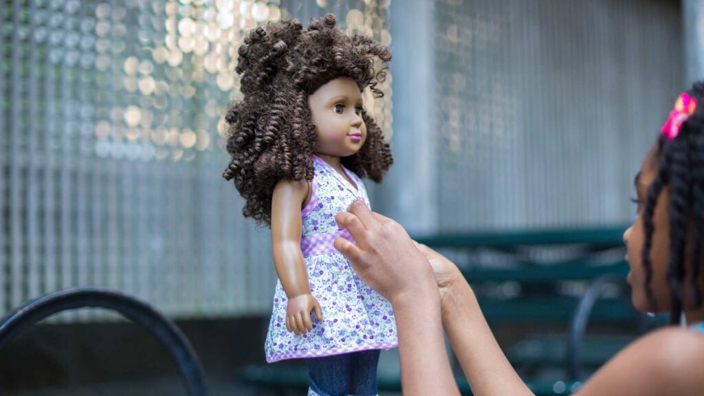 Child playing with an inclusive doll