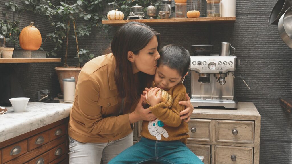 Parent comforting a young child at home while learning about early autism diagnosis, autism screening, and early intervention support.