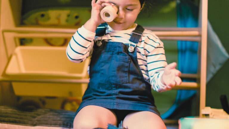 Child playing with a toy in a sensory-friendly room, representing early autism diagnosis and early signs of autism in young children.