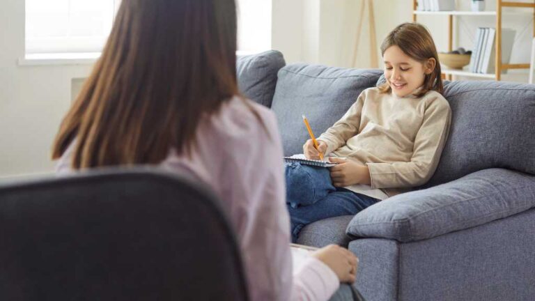 Therapist supporting a child during a session, illustrating Acceptance and Commitment Therapy (ACT) integrated with ABA therapy to support emotional regulation and learning.