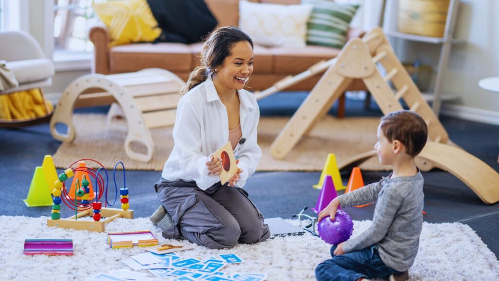 Aba therapist working with a young child during play, illustrating how early should aba therapy start and how early intervention for autism can support learning.