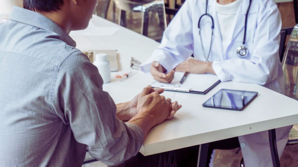Parents discuss autism concerns with a specialist while their child expresses big emotions, showing how to talk to a pediatrician about autism.
