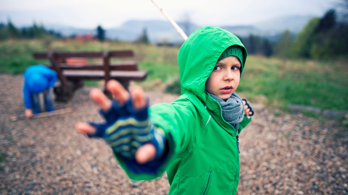 A young Jedi celebrates May the 4th Star Wars Day playing light sabers in the park