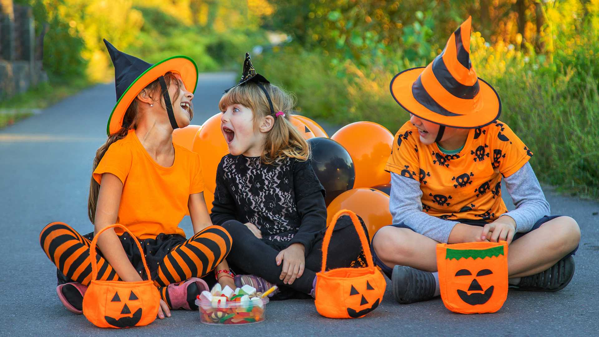 Children in Halloween costumes laughing together outdoors, representing an autism-friendly Halloween experience supported by Texas ABA Centers.