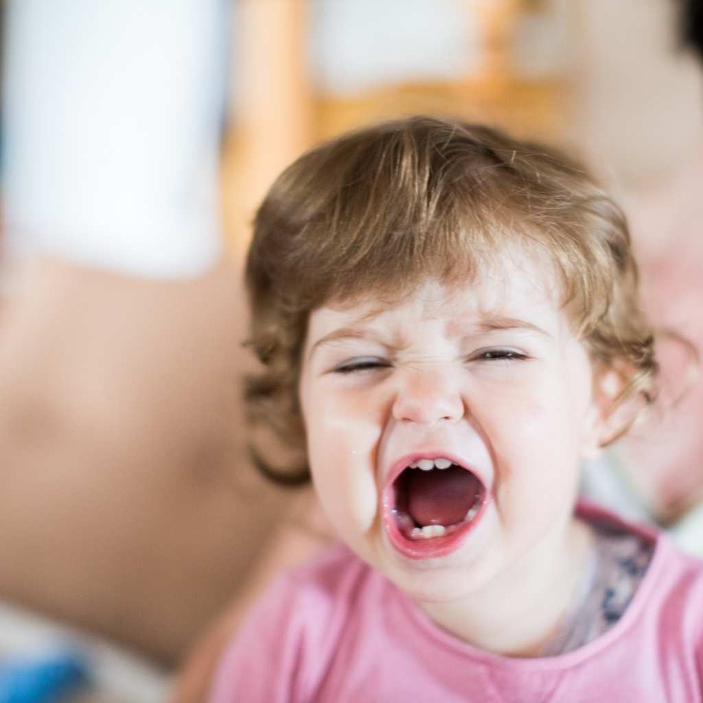 Young child expressing frustration during a learning activity