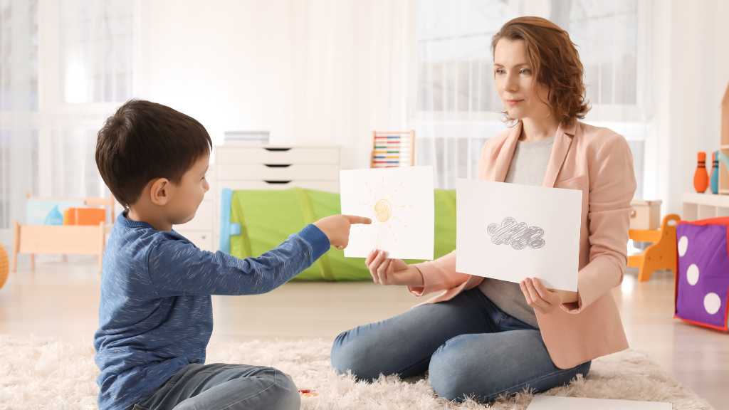 Child participating in autism assessment activity with therapist—illustrating the evaluation process and early signs of autism.