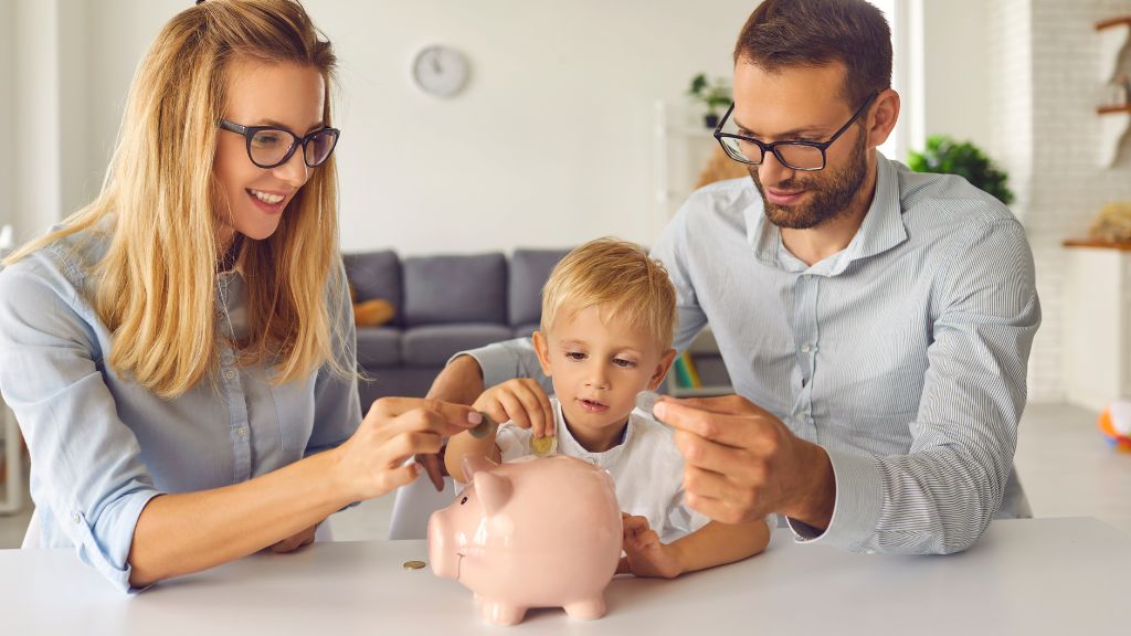 Family putting coins into a piggy bank while planning expenses