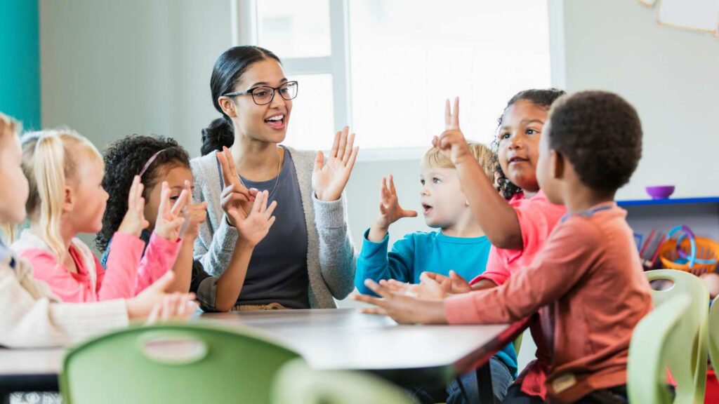 Advocacy And Autism: Advocating For Your Child At School Teacher leading an interactive classroom activity with diverse group of students