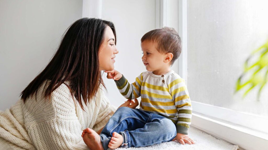 Aba Therapy Progress: What Does It Look Like And Why It'S Not Always Linear? Parent and toddler smiling while interacting face to face at home